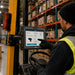 Forklift operator using AgozTech Getac tablet mount holder for picking workflow in warehouse operations