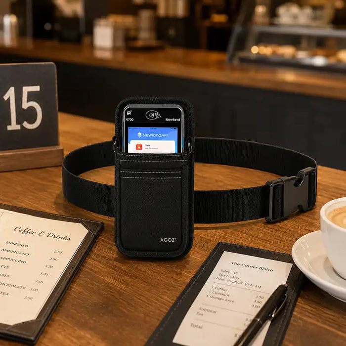 AgozTech black Newland POS waist belt holster displayed on a cafe table with receipt, menu, and checkout items.