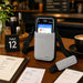 AgozTech gray Newland POS crossbody sling holster with shoulder strap displayed on a cafe service table.