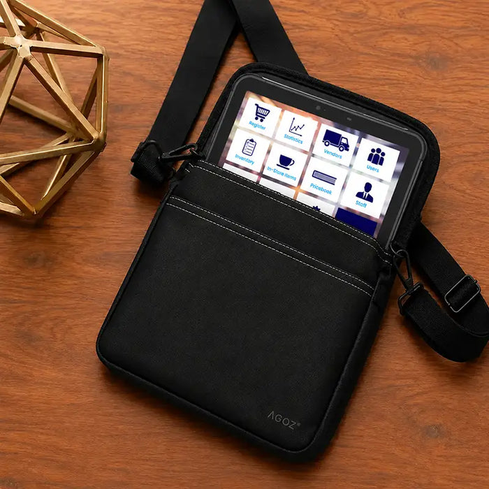 Black Agoz PAX payment tablet case with adjustable crossbody shoulder sling and front storage pocket, displayed on a wooden table.