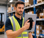 Man using a Panasonic tablet with handgrip in warehouse