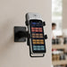 SpotOn Handheld POS terminal mounted in an AgozTech wall mount POS stand against a cafe wall