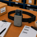 A gray waist belt case with a honeywell mobile scanner on a packing table