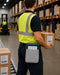 Worker in a warehouse holding a box and using a tablet waist belt case.