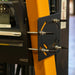 Close-up of AgozTech forklift printer mount bracket with metal rods, washers, and black mounting plate secured to forklift frame.