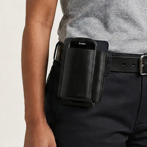 Zebra mobile computer seated in a black leather belt holster worn on a worker’s belt for hands-free carry.
