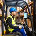 Warehouse forklift operator driving with a Unitech RT112 tablet mounted within easy viewing distance