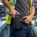 Worker removing Zebra TC52 mobile computer from AgozTech holster case on belt